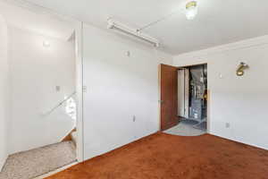 Unfurnished room with carpet and heating unit