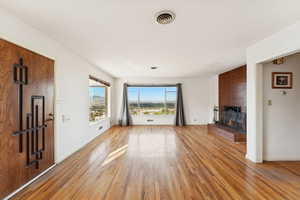 Unfurnished living room featuring a fireplace and hardwood / wood-style floors