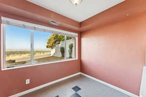 Spare room with baseboards and a textured wall