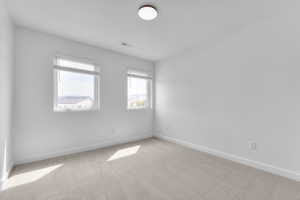 Unfurnished room with carpet flooring and baseboards