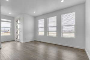 Unfurnished room with light wood-type flooring and recessed lighting
