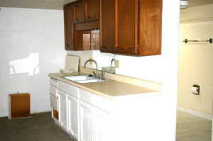 Kitchen with light countertops and a sink
