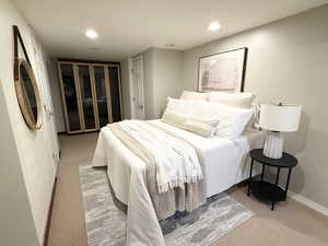 Carpeted bedroom with baseboards and recessed lighting