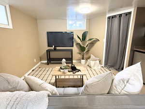Living area with carpet and baseboards
