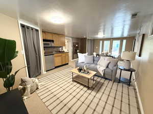 Living room featuring baseboards and light colored carpet