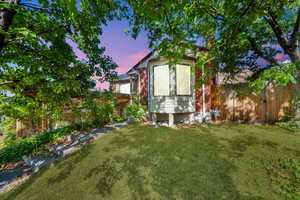 Rear view of house featuring brick siding