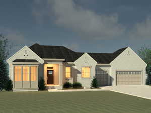 View of front facade featuring an attached garage, concrete driveway, and brick siding
