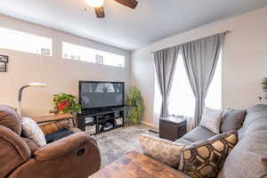 Living room featuring wood finished floors and a ceiling fan