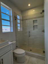 Upstairs full bathroom featuring vanity, a stall shower, and recessed lighting