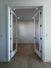 Office featuring french doors, light engineered hardwood floors, and recessed lighting