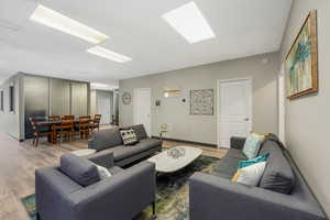 Living area with wood finished floors and baseboards