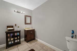 Half bath with vanity and light tile patterned floors