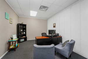 Home office featuring dark colored carpet and a drop ceiling