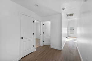 Hall with baseboards and wood finished floors