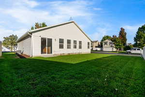 Back of house with a lawn