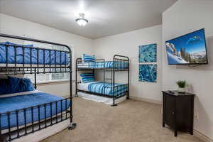 Bedroom featuring light colored carpet and baseboards