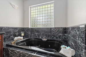 Bathroom view of a tub with jets