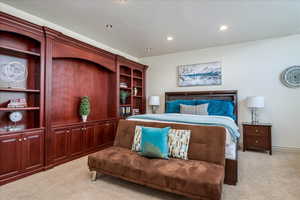 Bedroom with recessed lighting and light colored carpet