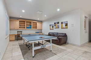 Rec room featuring built in desk, recessed lighting, and light tile patterned floors