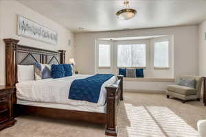 Bedroom with light carpet and baseboards