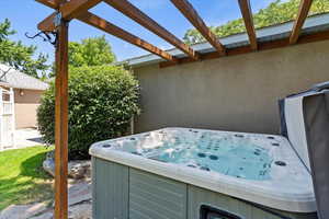 View of patio featuring a hot tub
