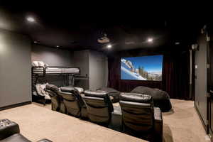 Cinema with light colored carpet and recessed lighting