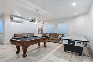Rec room featuring recessed lighting, billiards table, light tile patterned floors, and a wall mounted air conditioner