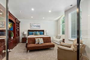 Bedroom with light colored carpet and recessed lighting