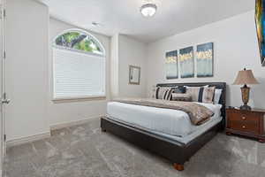 Bedroom featuring carpet and baseboards