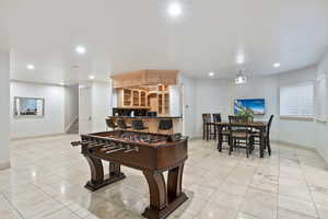 Recreation room featuring recessed lighting and light tile patterned flooring