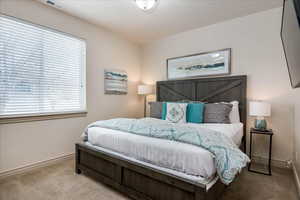 Carpeted bedroom with baseboards