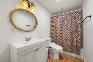 Full bathroom with shower / tub combo with curtain and vanity