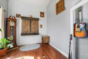 Interior space featuring dark wood-style floors with water feature