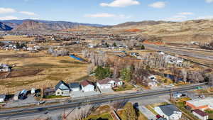 View of property location with a mountain backdrop and nearby suburban area