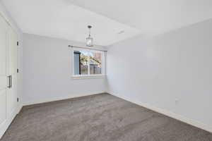 Unfurnished room featuring carpet and baseboards