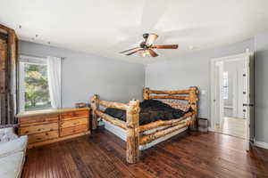 Bedroom featuring dark wood-style flooring and ceiling fan