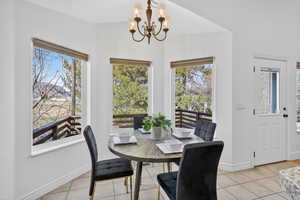 Dining room featuring a chandelier and light tile  floors