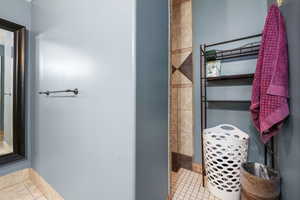 Bathroom with walk in shower featuring tile  flooring