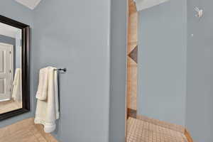 Full bath with tile  flooring and tiled shower