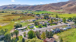 Aerial view of property's location with mountains and nearby suburban area