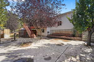 Rear view of property featuring stairs large deck covered patio