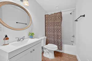 Bathroom with vanity and shower / bathtub combination with curtain