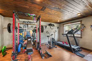 Exercise room with wood ceiling and wood finished floors