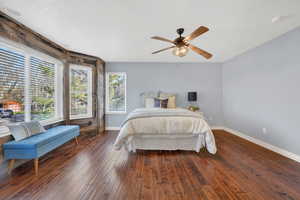 Bedroom with a ceiling fan and hardwood / wood-style floors