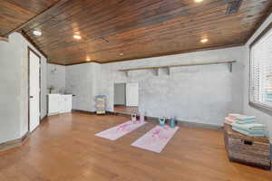 Unfurnished room with wooden ceiling, light wood-style flooring, and recessed lighting