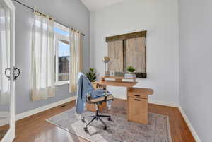 Home office featuring hardwood / wood-style floors