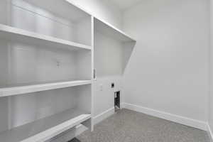 Laundry area with hookup for a washing machine, hookup for an electric dryer, and speckle patterned floor