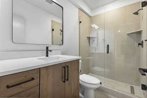 Full bath featuring vanity and a shower stall