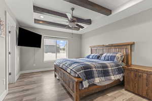 Bedroom with beam ceiling, light wood-type flooring, a ceiling fan, and recessed lighting