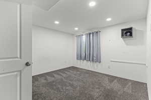 Carpeted spare room featuring recessed lighting